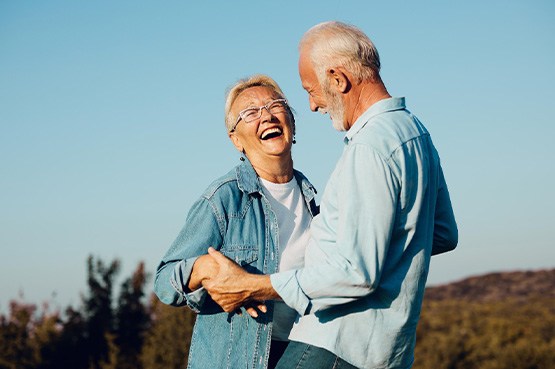 Couple smiling in hilltop outside