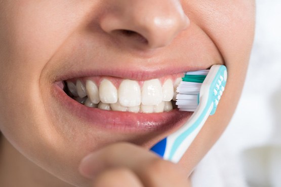 a dental patient brushing her teeth