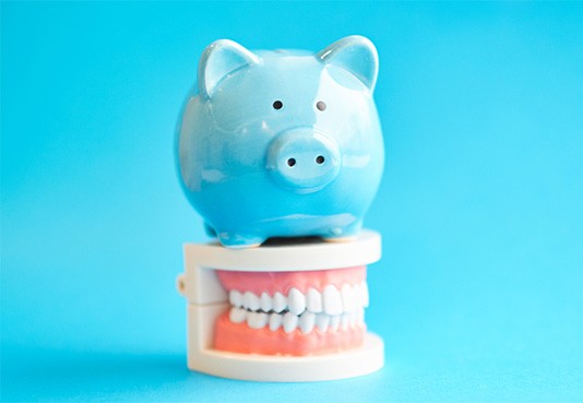 A piggy bank with a set of model teeth
