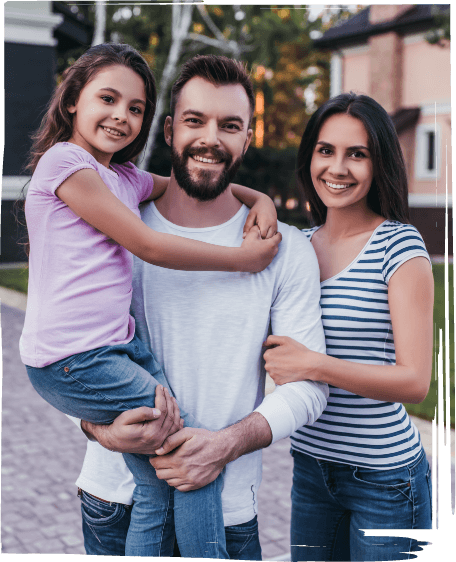 Family of three smiling outdoors