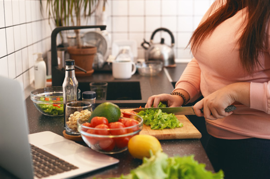 Woman chopping vegetables in kitchen