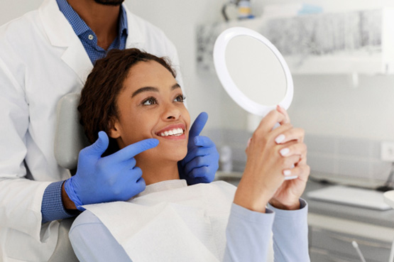 Woman smiling at reflection in mirror
