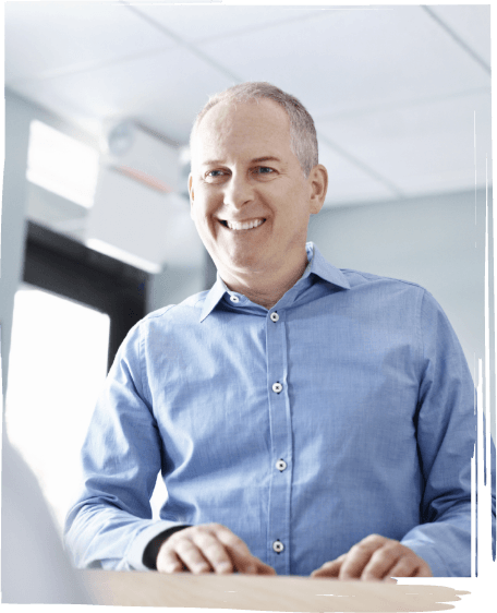 Man smiling at dental office receptionist