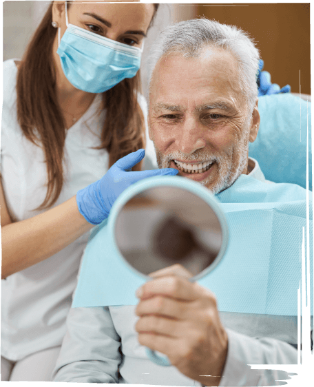 Senior dental patient looking at his smile in mirror