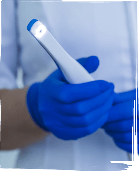 Dental team member holding thin white intraoral camera