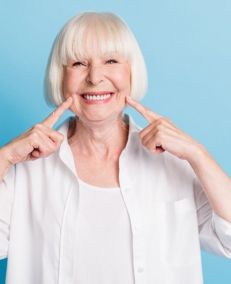 a dentures patient smiling confidently 