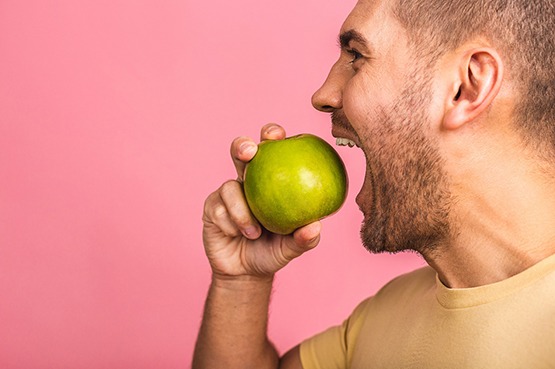 a man biting into an apple
