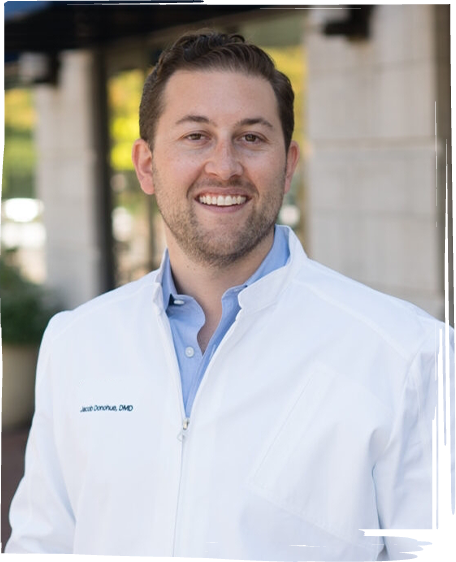 Worcester dentist Doctor Jacob Donohue smiling in white lab coat