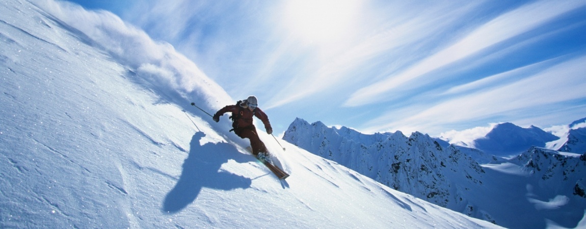 Person skiing down a snowy mountain