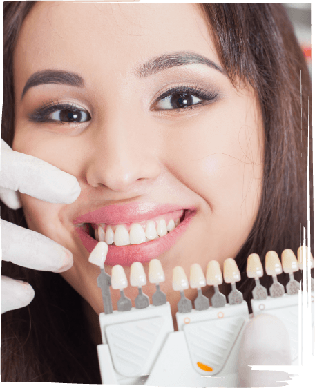 Young woman in dental chair smiling while being fitted for veneers in Worcester
