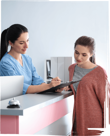 Dental team member showing a clipboard to a patient