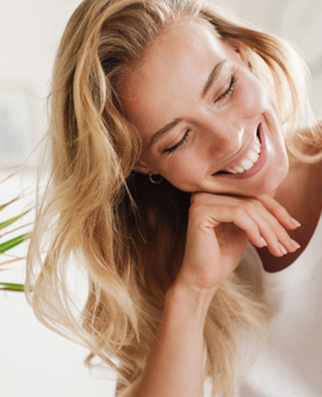 Woman with white teeth smiling at home