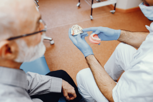 a patient and their dentist discussing dentures